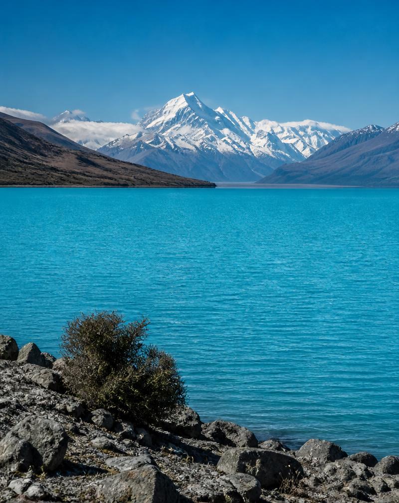 Glacial blue Lake Pukaki with snow-capped Aoraki Mount Cook behind