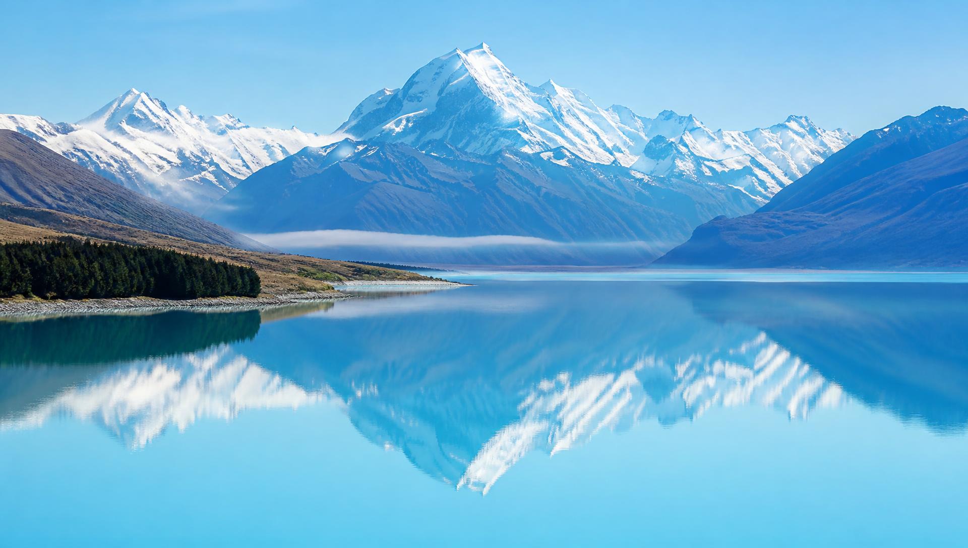 Glacial blue Lake Pukaki with Aoraki Mount Cook reflected on a clear day